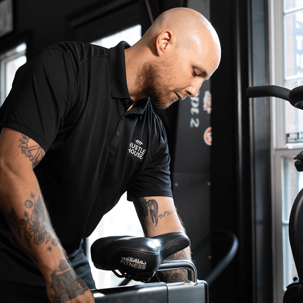 Matt Ribley, Owner and Head Coach, at the cable machine at Hustle House Health & Wellness in Woodstock, GA