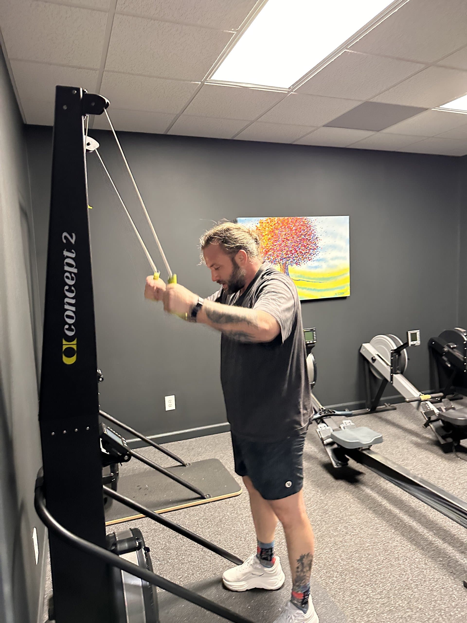 A member using the cable lat pulldown machine at Hustle House Health & Wellness in Woodstock, GA