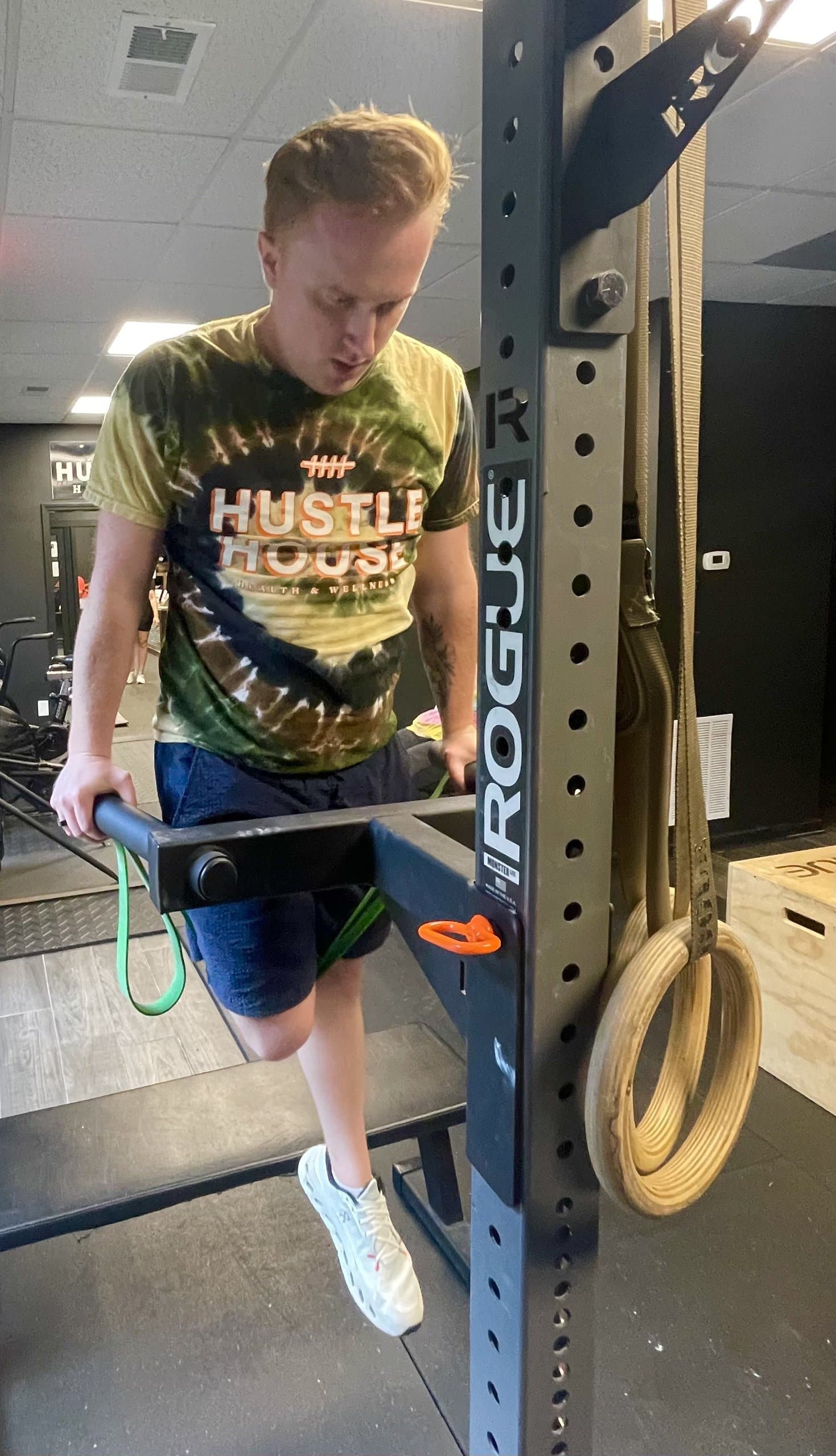A member performing dips on the power rack at Hustle House Health & Wellness in Woodstock, GA