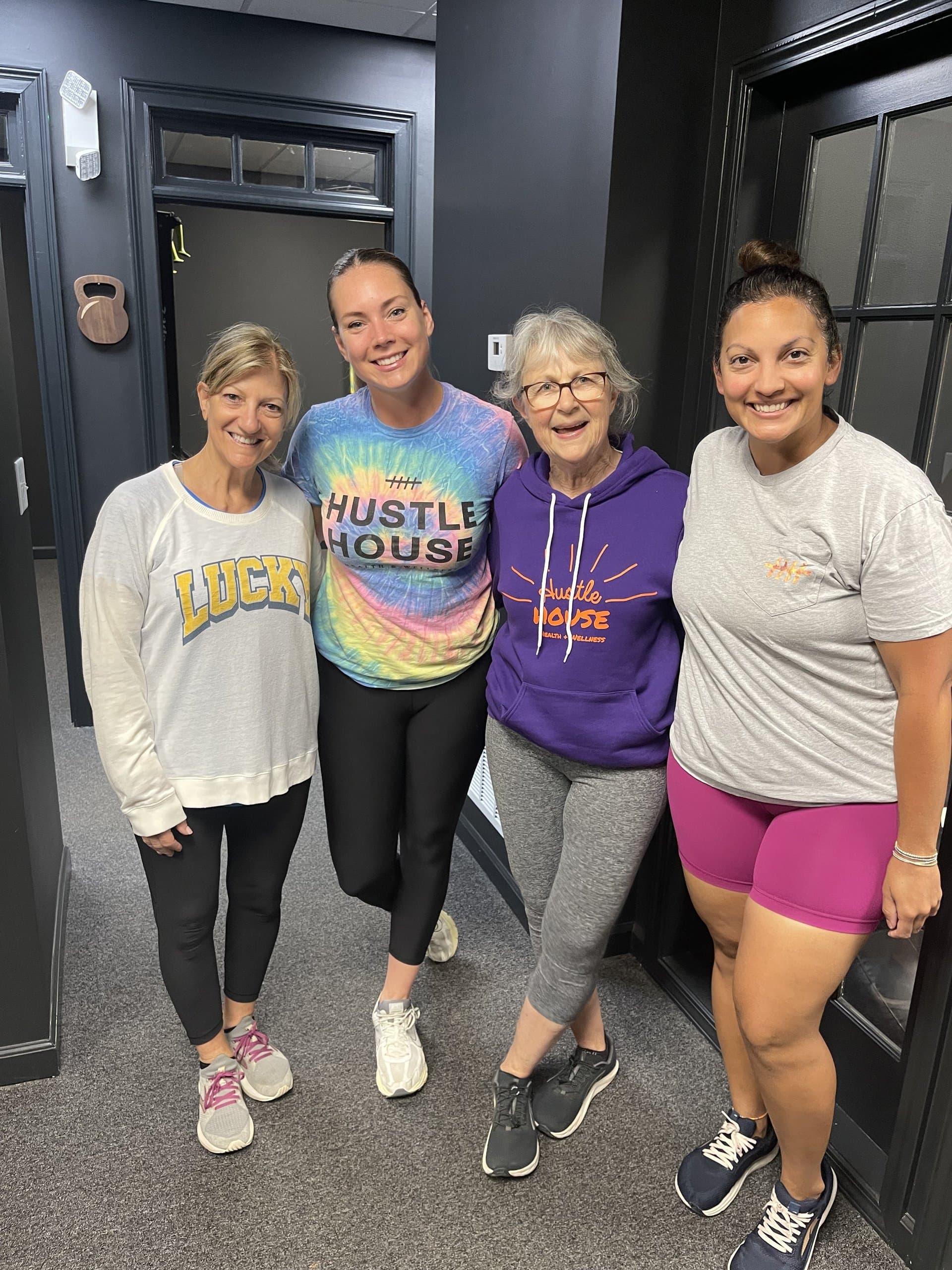 Members together in the hallway at Hustle House Health & Wellness in Woodstock, GA