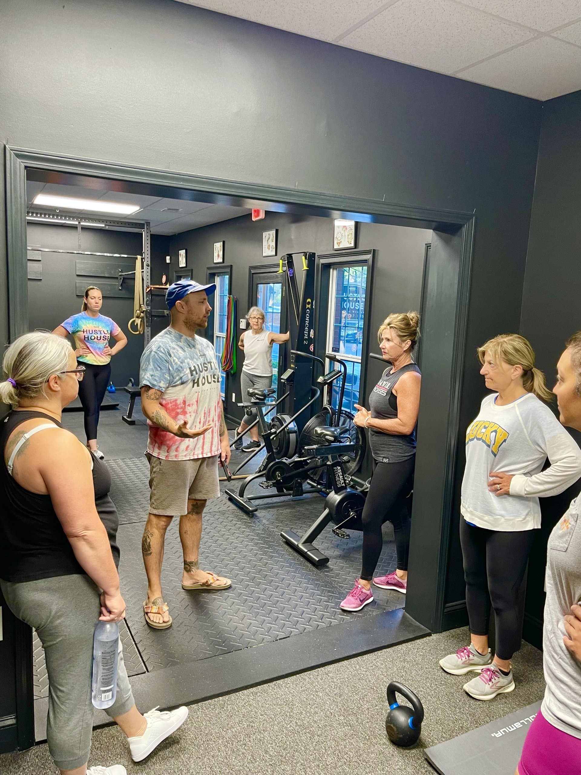 A coach briefing a small group class at Hustle House Health & Wellness in Woodstock, GA