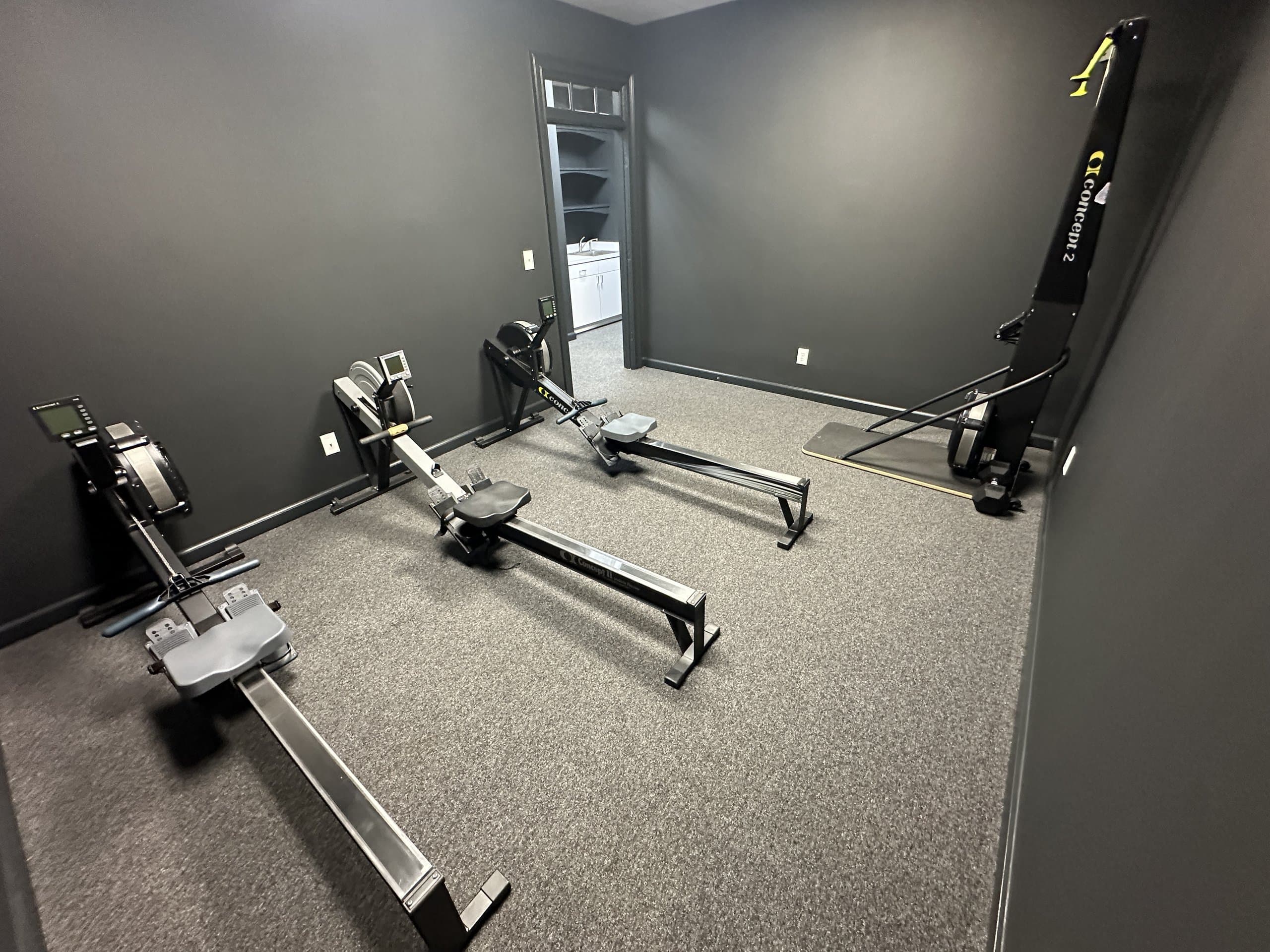 The rowing machine room at Hustle House Health & Wellness in Woodstock, GA
