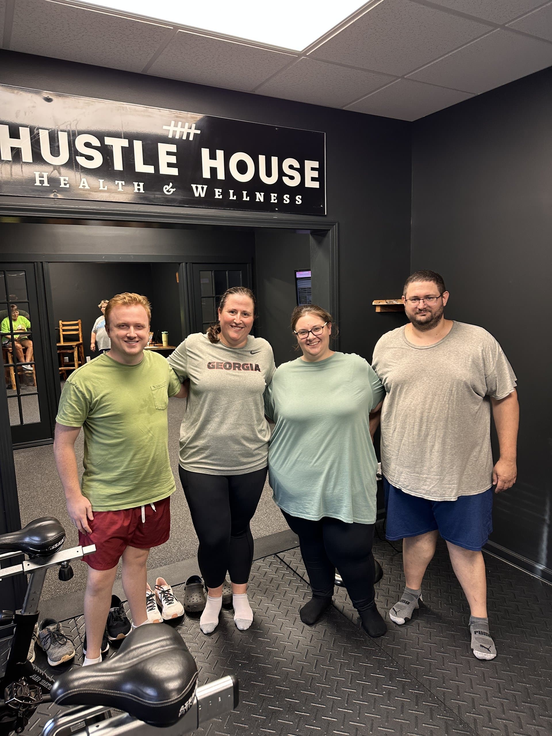 Members at the entrance of Hustle House Health & Wellness in Woodstock, GA